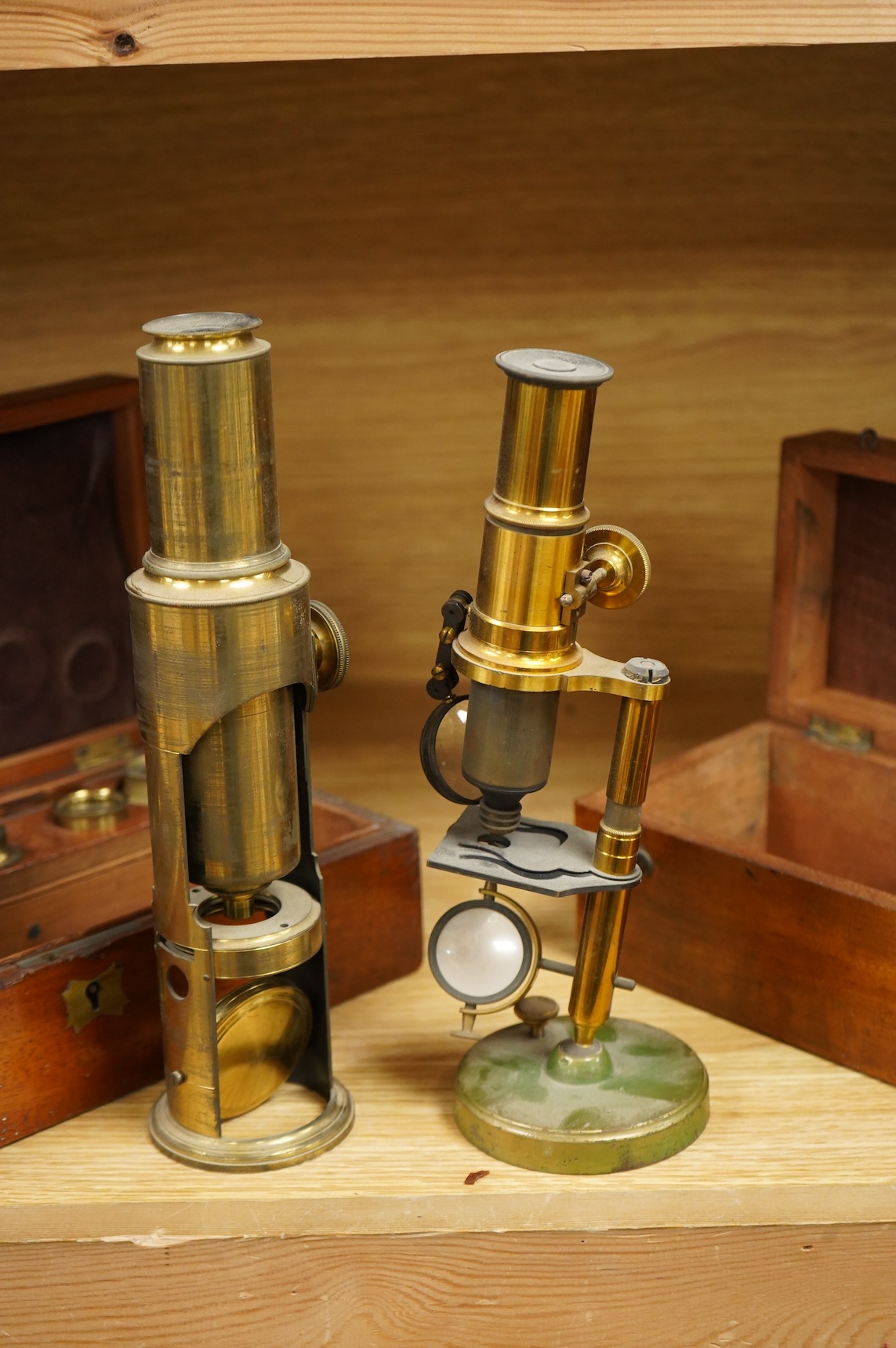 Two microscopes; an early 19th century Martin type brass compound monocular microscope, with five numbered objectives, specimen tube and hand magnifier, mahogany case 27cm wide, together with a late 19th/early 20th centu